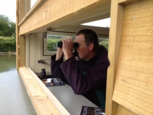 Grounds Manager Paul Stevens watches wildlife on Arun Riverlife with the binoculars avalaible in the hide.