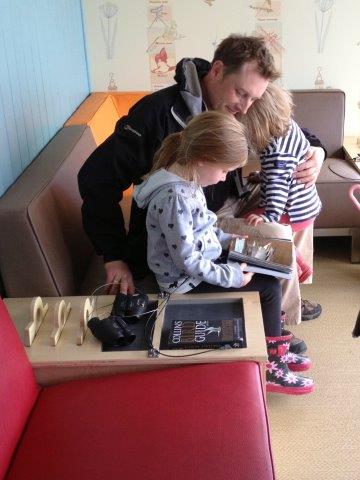 Molly & Erin look at birding books with daddy Declan Shelvin during the hide preview for contest winners.