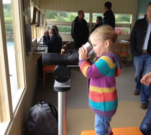 Young Sophie Rooney watches an oysterctcher through a new viewing scope.