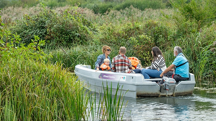 family enjoying a guided boat tour at WWT Arundel