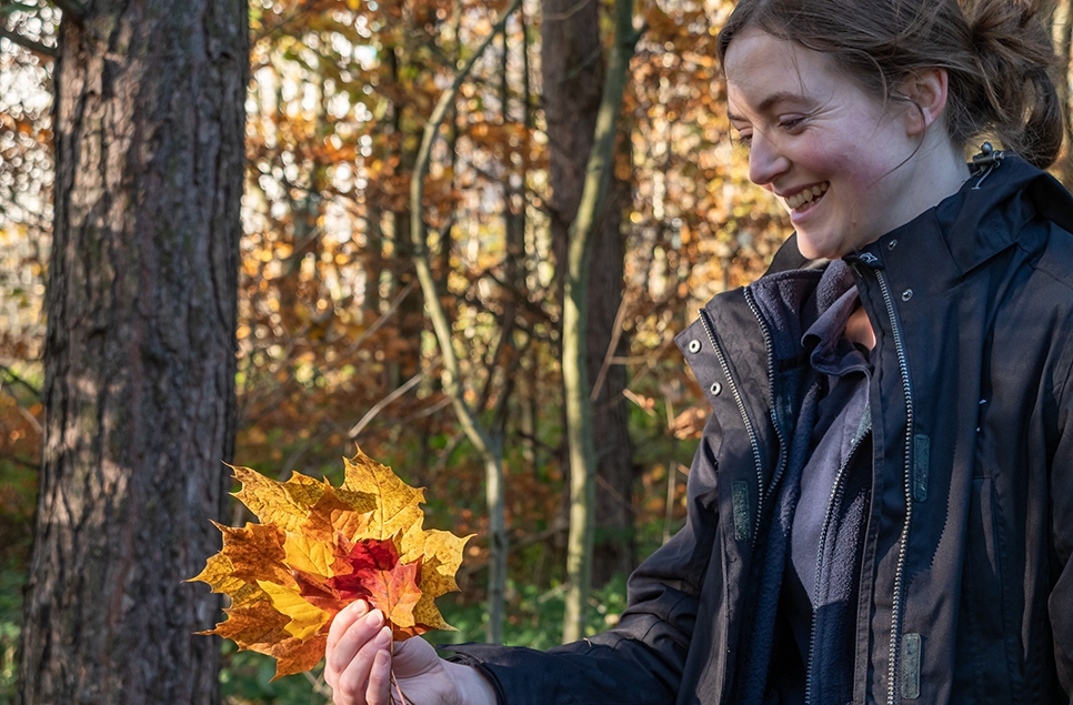 Kate holding autumn leaves