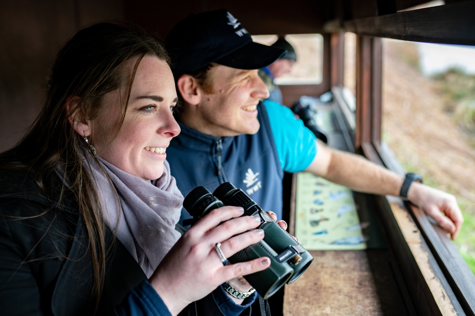 Deborah Nolan with reserve warden Andrew Diamond and a visitor in a bird hide.