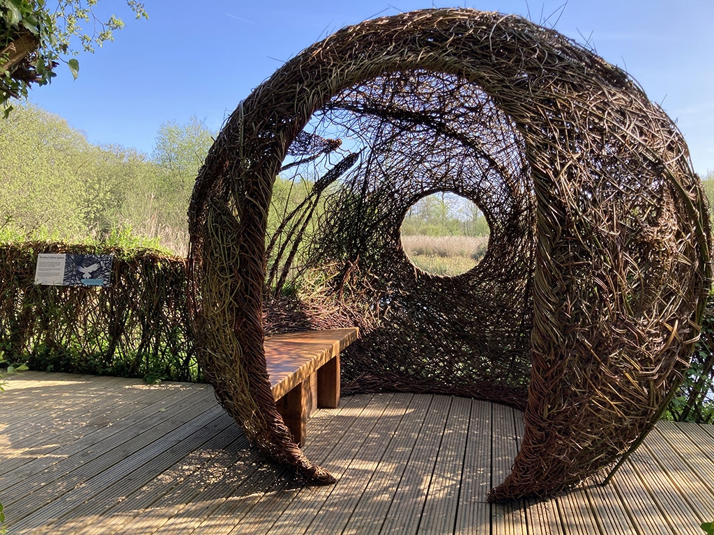 The Reedbed Willow Sphere at Arundel, surrounded by blue sky