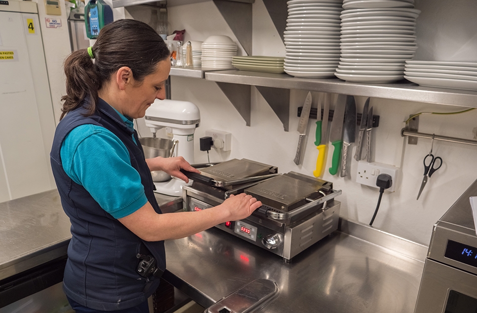 Lesley using the grill in the kitchen